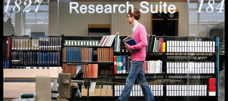 librarian in front of a bookshelf