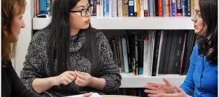 Three people in discussion 